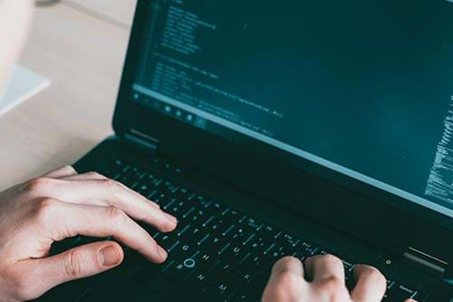 hands typing on a computer