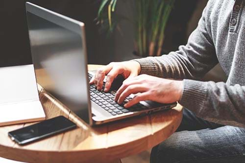 A Bellevue student programs on their laptop while in their online class for their computer science degree.