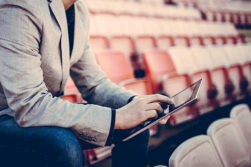 hands exchanging sports ticket