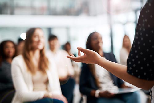 person talking in front of a group