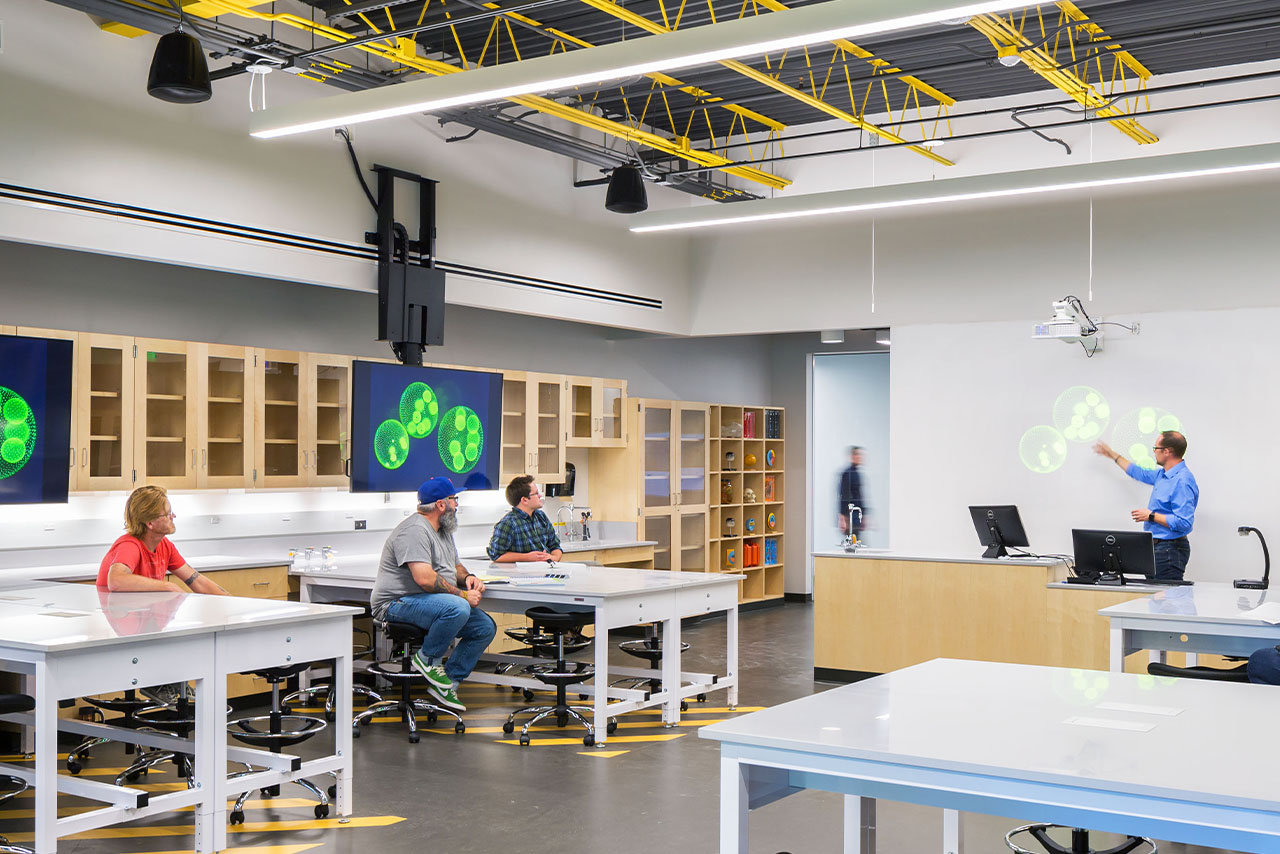 Instructor leading a class discussion in a science lab on campus.